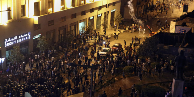 Lebanese riot police use tear gas during a protest against the ongoing trash crisis, in downtown Beirut, Lebanon, Saturday, Aug. 22, 2015. Police have unleashed tear gas and water cannons on thousands of Lebanese demonstrating in downtown Beirut against government corruption and political dysfunction that has left garbage accumulating in the streets in suburbs of the capital for over a month. (AP Photo/Bilal Hussein)