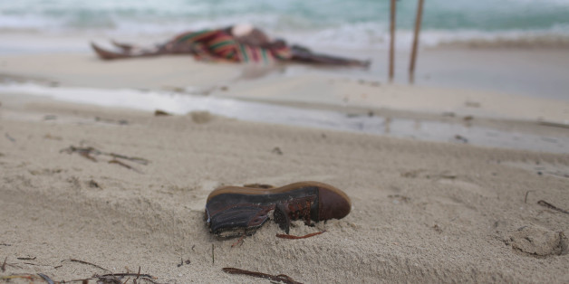 This Oct. 2, 2014 photo shows the clothes and shoes of migrants who washed up on the beach on the beach of Zwara, Libya on a dangerous journey for a better life in Europe. The 140 people killed that day off Zwara presaged the horrors of recent months as more than 1,800 migrants en route to Europe from places like Libya have drowned in the Mediterranean this year alone, according to the International Organization for Migration.(AP Photo/Mohamed Ben Khalifa)