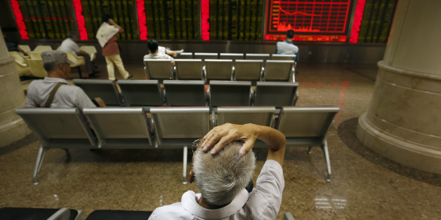 Chinese investors monitor stock prices at a brokerage house in Beijing, Monday, Aug. 24, 2015. Stocks tumbled across Asia on Monday as investors shaken by the sell-off last week on Wall Street unloaded shares in practically every sector. (AP Photo/Mark Schiefelbein)