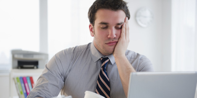 USA, New Jersey, Jersey City, Bored business man working on laptop