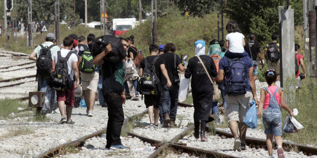 IDOMENI, GREECE - AUGUST 24: Immigrants and refugees approach the Greece Macedonian border to Gevegelia where they hope to get a train to take them to Serbian border, on August 24, 2015 in Idomeni, Greece. Thousands of migrants and refugees have arrived on the border between Greece and Macedonia with many trying to travel through Macedonia to reach northern Europe. Macedonia border police have begun to let immigrants in small groups to cross the border in an attempt to avoid the chaos of previo