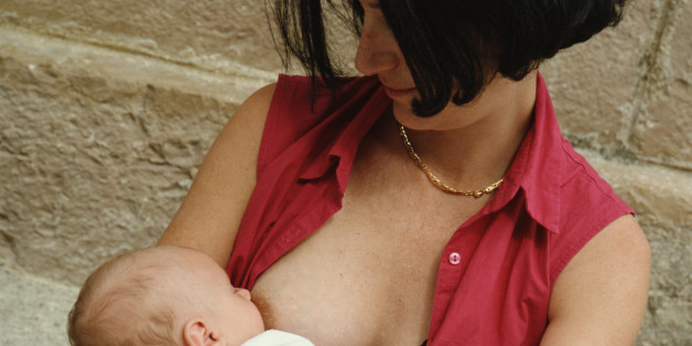 Mother breast feeding baby girl (0-3 months), close-up