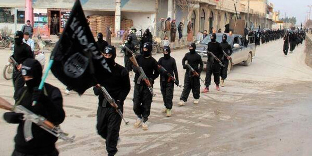 FILE - This undated file image posted on a militant website on Tuesday, Jan. 14, 2014, which has been verified and is consistent with other AP reporting, shows fighters from the al-Qaida linked Islamic State of Iraq and the Levant (ISIL), now called the Islamic State group, marching in Raqqa, Syria. An online image released Wednesday, Aug. 12, 2015, purported to show the Islamic State affiliate in Egypt had beheaded a Croatian hostage. (AP Photo/Militant Website, File)