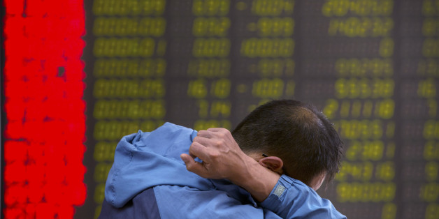 A Chinese investor monitors stock prices at a brokerage house in Beijing, Tuesday, Aug. 25, 2015. China's main stock market index has fallen for a fourth day, plunging 7.6 percent to an eight-month low. (AP Photo/Mark Schiefelbein)