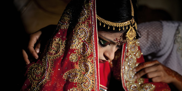 MANIKGANJ, BANGLADESH - AUGUST 20: 15 year old Nasoin Akhter is consoled by a friend on the day of her wedding to a 32 year old man, August 20, 2015 in Manikganj, Bangladesh. In June of this year, Human Rights Watch released a damning report about child marriage in Bangladesh. The country has one of the highest rates of child marriage in the world, with 29% of girls marrying before the age of 15, and 65% of girls marrying before they turn 18. The detrimental effects of early marriage on a girl cannot be overstated. Most young brides drop out of school. Pregnant girls from 15-20 are twice as likely to die in childbirth than those 20 or older, while girls under 15 are at five times the risk. Research cites spousal age difference as a significant risk factor for violence and sexual abuse. Child marriage is attributed to both cultural tradition and poverty. Parents believe that it 'protects' girls from sexual assault and harassment. Larger dowries are not required for young girls, and economically, women's earnings are insignificant as compared to men's. (Photo by Allison Joyce/Getty Images)