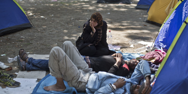 Migrants from Syria rest at a park in Belgrade, Serbia, Wednesday, Aug. 26, 2015. Thousands of migrants, including many women with babies and small children, have crossed into Serbia over the past few days and are heading toward Hungary and the E.U. (AP Photo/Marko Drobnjakovic)