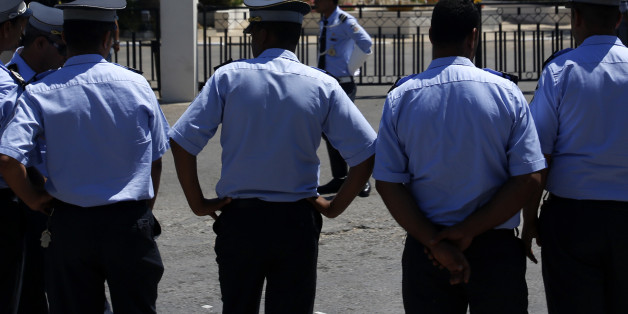 Tunisian police officers guard Imperial Marhaba hotel during visit of top security officials of Britain, France, Germany and Belgium in Sousse, Tunisia, Monday, June 29, 2015. British Home Secretary Theresa May, French Interior Minister Bernard Cazeneuve, German Interior Minister Thomas de Maiziere and Belgian Interior Minister Jan Jambon joined their Tunisian counterpart on the beach in front of the Imperial Marhaba hotel in the Mediterranean resort of Sousse for the tribute Monday. (AP Photo/