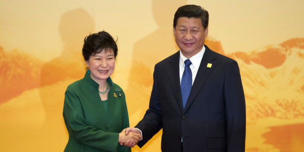 South Korean President Park Geun-hye shakes hands with Chinese President Xi Jinping during a welcome ceremony for the Asia-Pacific Economic Cooperation (APEC) Economic Leaders Meeting held at the International Convention Center in Yanqi Lake, Beijing, on Tuesday, Nov 11, 2014. (AP Photo/Ng Han Guan)
