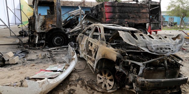 Burned vehicles remain in the Industrial Stadium a day after a series of bombs exploded in eastern Baghdad, Iraq, Saturday, April 26, 2014. Suicide bombers killed dozens of people Friday at a sports stadium hosting a campaign rally for thousands of supporters of a militant Shiite group before parliamentary elections, authorities said â an attack that could unleash more sectarian violence. (AP Photo/Karim Kadim)