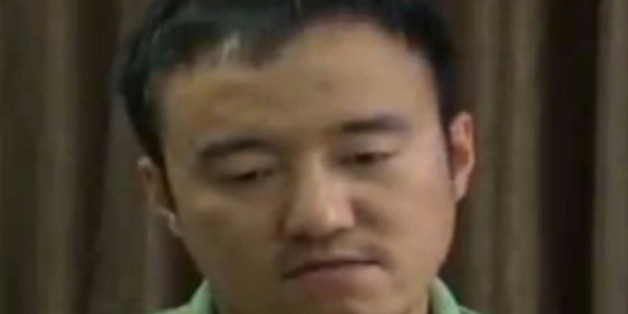 Une capture d'écran de CCTV montrant Wang Xiaolu, un journaliste financier qui a "avoué" avoir provoqué "le désordre" sur les marchés boursiers