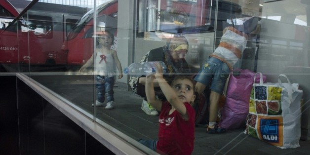 Des enfants syriens et leurs parents attendent un train pour l'Allemagne, dans la gare de Vienne en Autriche le 31 août 2015