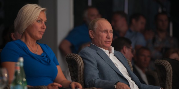 SOCHI, RUSSIA - AUGUST 29: Russian super middleweight boxing champion Natalia Ragozina (L) and Russia's President Vladimir Putin (R) attend the Plotforma S-70 international professional combat sambo tournament of League S-70 in Sochi, Russia, on August 29, 2015. (Photo by NINA ZOTINA/Anadolu Agency/Getty Images)
