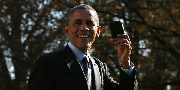 WASHINGTON, DC - NOVEMBER 21: U.S. President Barack Obama holds up his Blackberry after he ran back into the White House after forgetting the mobile phone while departing for a domestic trip November 21, 2014 in Washington, DC. Obama is scheduled to travel to Las Vegas later today to speak about immigration reform. (Photo by Win McNamee/Getty Images)