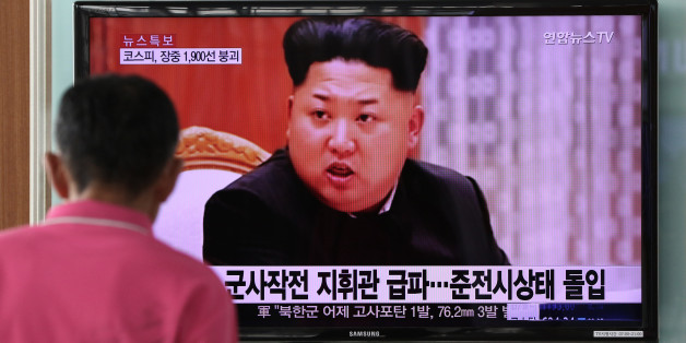 A man looks at a television screen showing an image of Kim Jong Un, leader of North Korea, during a news broadcast on North Korea's exchange of fire with South Korea at Seoul Station in Seoul, South Korea, on Friday, Aug. 21, 2015. North Korean leader Kim Jong Un ordered his army to prepare for war after an exchange of fire with South Korea, ratcheting up the rhetoric as the latest skirmish between the two nations intensifies. Photographer: SeongJoon Cho/Bloomberg via Getty Images