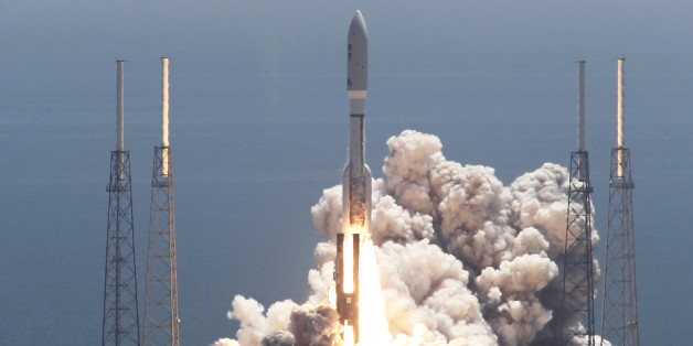 An Atlas V rocket with the Juno spacecraft lifts off from Space Launch Complex-41 in Cape Canaveral, Fla. on Friday, Aug. 5, 2011. NASA launched the spacecraft atop an unmanned rocket that blasted into a clear midday sky as scientists cheered and yelled "Go Juno!" It was the first step in Juno's 1.7 billion-mile voyage to the gas giant Jupiter, just two planets away but altogether different from Earth and next-door neighbor Mars. (AP Photo/Terry Renna)