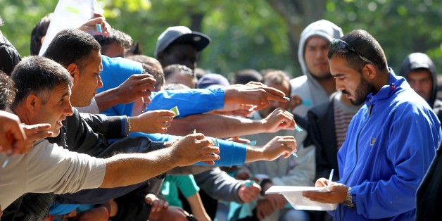 BERLIN, GERMANY - SEPTEMBER 03: Hundreds of Syrian and Afghan migrants wait to register in front of the State Office for Health and Social Affairs (LaGeSo) in Berlin, Germany on September 03, 2015. (Photo by Mehmet Kaman/Anadolu Agency/Getty Images)
