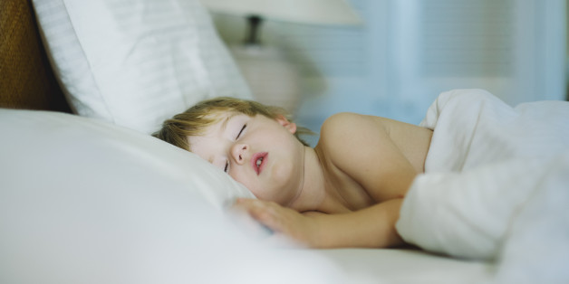 Young sleeping boy in a hotel room.
