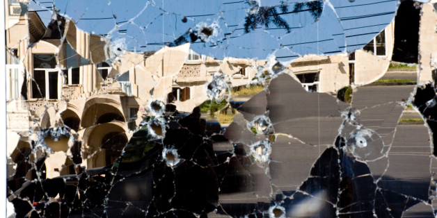 GORI, GEORGIA - AUGUST 28: Shop windows riddled with bullets reflect the Joseph Stalin statue and government building at the main square August 28, 2008 in Gori, Georgia. As Russian President Dmitri A. Medvedev found little support for Russia's military incursion into Georgia earlier this month at an annual meeting of the regional security group Shanghai Cooperation Organization in Dushanbe, Tajikistan, Russian Prime Minister Vladimir V. Putin suggested in a television interview in Sochi, Russia