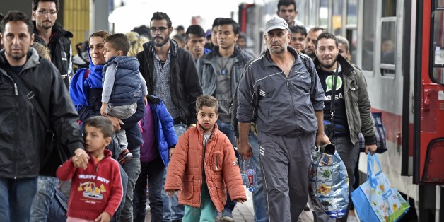 Refugees from Syria arrive at the train station in Dortmund, Germany, Sunday, Sept. 6, 2015. Thousands of migrants and refugees arrived in Dortmund by trains. (AP Photo/Martin Meissner)