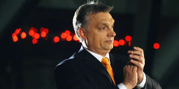 Hungarian Prime Minister Viktor Orban, leader of the ruling center-right Fidesz party applauds prior to his victory speech after the parliamentary elections in downtown Budapest, Hungary, late Sunday, April 6, 2014. (AP Photo/MTI, Laszlo Beliczay)