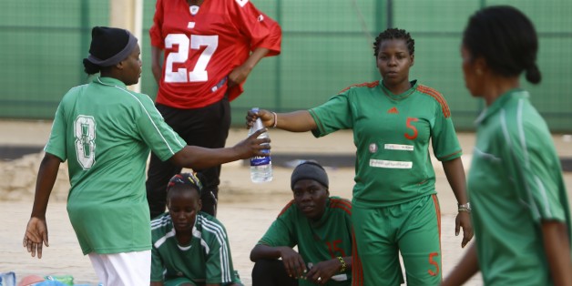 TO GO WITH AFP STORY BY TOM LITTLE Sudanese female football players from 'The Challenge' team take part in a training session at a picth near Khartoum's aiport on August 13, 2015. On a dirt pitch next to Khartoum airport, Sara Edward watches the players she hopes to mould into Sudan's first national women's football team hone their skills, kicking up clouds of dust. Her 15 players have taken the name 'The Challenge' because of the obstacles they face -- no equipment, no funding and the suspicion