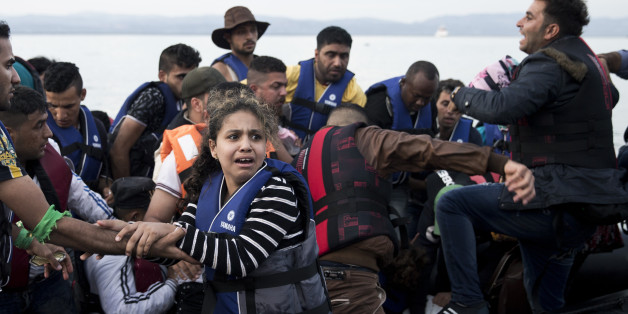 Syrian refugees arrive on a dinghy after crossing from Turkey to Lesbos island, Greece, Wednesday, Sept. 9, 2015. The head of the European Union's executive says 22 of the member states should be forced to accept another 120,000 people in need of international protection who have come toward the continent at high risk through Greece, Italy and Hungary. (AP Photo/Petros Giannakouris)