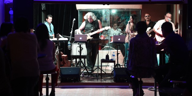 TO GO WITH PAKISTAN-SOCIETY-NIGHTCLUB-CULTURE BY GUILLAUME LAVALLEEIn this photograph taken on August 21, 2015, Pakistani owner of private nightclub 'Hard Rock Cafe' Akeel Akhtar (C), performs with other muscians in Karachi. Karachi, Pakistan's biggest and most diverse city, was once home to a famous nightclub scene where alchohol flowed freely and luminaries from the world of jazz played to packed crowds eager for Western culture. The golden-era began in the fifties and rolled on until prohib