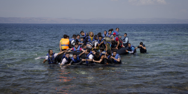 Refugees and migrants arrive on a dinghy after crossing from Turkey to Lesbos island, Greece, Friday, Sept. 11, 2015. While migrants for years have taken death-defying trips across the Mediterranean to reach the relative peace and comfort of the Europe Union, the flow has hit record proportions this year _ notably with an influx of Syrians, Afghans and Eritreans fleeing trouble back home.(AP Photo/Petros Giannakouris)