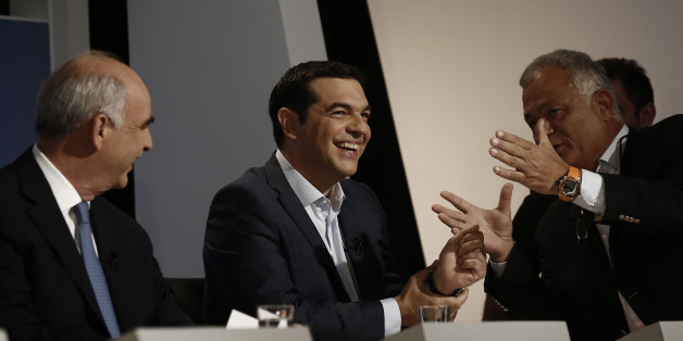 Alexis Tsipras, former Greek prime minister, center, and Evangelos Meimarakis, leader of the New Democracy Party of Greece, left, speak with ERT managing director Lampis Tagmatarhis prior a television debate at the studios of Greek state broadcaster ERT, also known as the Hellenic Broadcasting Organisation, in Athens, Greece, on Wednesday, Sept. 9, 2015. An opinion poll over the weekend showed that no party is projected to gain enough votes for an outright parliamentary majority, signaling coali
