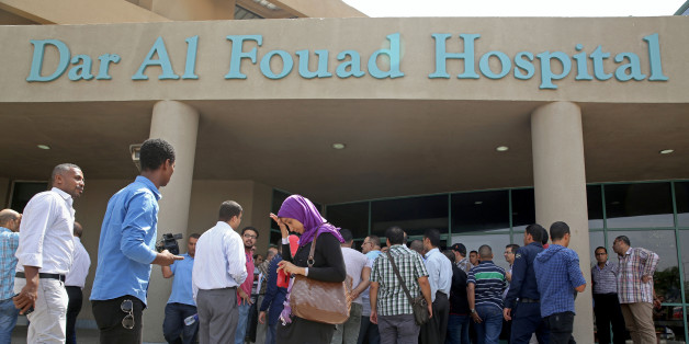 Egyptian journalists wait for information about tourists who were injured Sunday while on a desert safari trip, in front of the Dar Al Fouad Hospital in Cairo, Egypt, Monday, Sept. 14, 2015. At least 12 people were killed and 10 injured in Egypt's southwestern desert Sunday, Sept 13, 2015, when security forces mistakenly fired on a group of Mexican tourists, Egyptian officials said. The Mexican Foreign Ministry confirmed the incident and said at least two of the dead were Mexican nationals. (AP