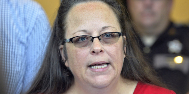 Rowan County Clerk Kim Davis makes a statement to the media at the front door of the Rowan County Judicial Center in Morehead, Ky., Monday, Sept. 14, 2015. Davis announced that her office will issue marriage licenses under order of a federal judge, but they will not have her name or office listed. (AP Photo/Timothy D. Easley)