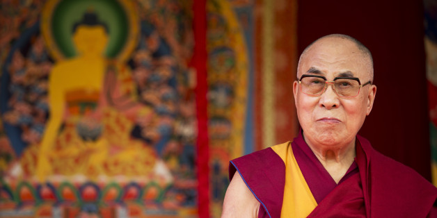Tibet's exiled government and Buddhist spiritual leader the Dalai Lama stands on stage before making a speech to an audience at the ESS Stadium in Aldershot, southern England, Monday, June 29, 2015. Before the speech on Monday, the exiled Tibetan spiritual leader inaugurated the Buddhist Community Centre UK. (AP Photo/Matt Dunham)