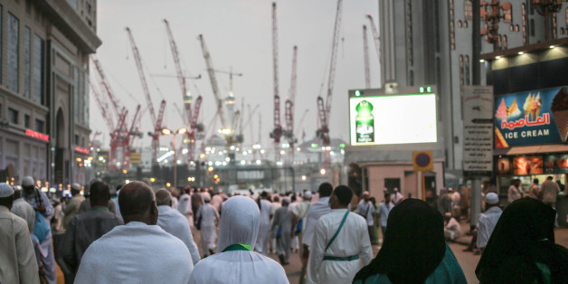Muslim pilgrims walk towards the Grand Mosque in the holy city of Mecca, Saudi Arabia, marked by towering cranes used in the ongoing expansion aimed to accommodate the growing numbers of annual pilgrims, Sunday, Sept. 13, 2015. A towering construction crane toppled over on Friday during a violent rainstorm in the Saudi city of Mecca, Islam's holiest site, crashing into the Grand Mosque and killing over a hundred people, ahead of the start of the annual hajj pilgrimage later this month. (AP Photo