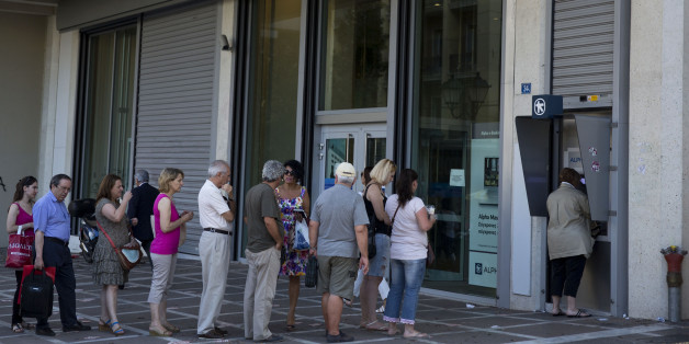 People line up to use an ATM machine outside a bank in Athens, on Monday, July 6, 2015. Greeceâs Finance Minister Yanis Varoufakis has resigned following Sundayâs referendum in which the majority of voters said ânoâ to more austerity measures in exchange for another financial bailout. (AP Photo/Petros Giannakouris)