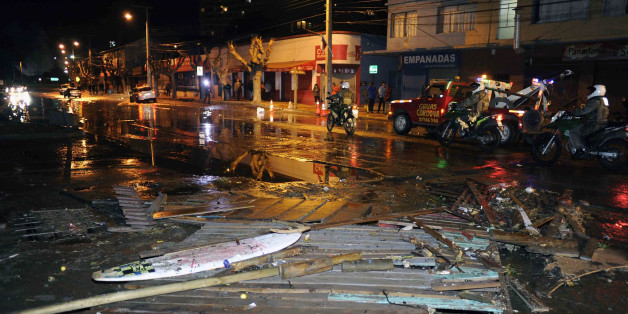 Police patrol a debris strewn street in Valparaiso, Chile, after a tsunami, caused by an earthquake hit the area, Wednesday, Sept. 16, 2015. A magnitude-8.3 earthquake hit off Chile's northern coast, causing buildings to sway in Santiago and other cities and sending people running into the streets. Authorities reported one death in a town north of the capital.(Pablo Ovalle Isasmendi/AGENCIA UNO via AP) CHILE OUT - NO USAR EN CHILE