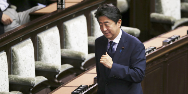 Japanese Prime Minister Shinzo Abe smiles during a vote of opposition-submitted no-confidence motion against his cabinet at the lower house of the parliament in Tokyo, Friday, Sept. 18, 2015. Opposition parties, in a last-ditch show of resistance, were delaying a vote on security bills by introducing a series of no-confidence measures against government ministers and parliamentary leaders on Friday. Japan's parliament is moving toward final approval of legislation that would loosen post-World Wa