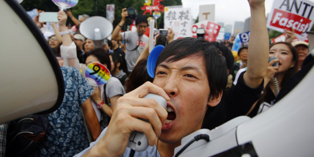 Protesters shout slogans during a rally in front of the National Diet building in Tokyo, Sunday, Aug. 30, 2015. Thousands of Japanese protested outside the parliament a set of security bills designed to expand the role the country's military. The bills - a cornerstone of Prime Minister's Shinzo Abe's move to shore up Japan's defenses in the face of growing threats in the region - are expected to pass next month despite criticism they undermine Japanâs post-war pacifism. (AP Photo/Shizuo Kam