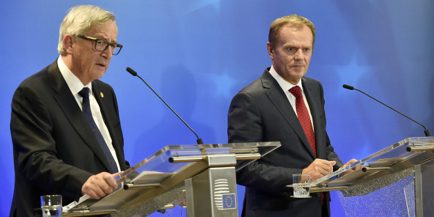 European Commission President Jean-Claude Juncker, left, and European Council President Donald Tusk, right, listen to the media after the emergency EU heads of state summit on the migrant crisis at the EU council building in Brussels on early Thursday, Sept. 24, 2015. European Union leaders, faced with a staggering migration crisis and deep divisions over how to tackle it, managed to agree early Thursday to send 1 billion euros ($1.1 billion) to international agencies helping refugees at camps n