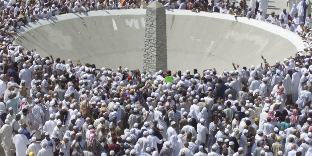 Muslims perform the ritual "Stoning of the Devil" on the second day of the ritual in Mina, near the holy city of Mecca in Saudi Arabia Wednesday, Feb. 12, 2003. Thousands of Muslim pilgrims threw pebbles at three stone pillars representing the devil in the last ritual of the five-day hajj, or annual pilgrimage. The ritual which symbolizes the rejection of earthly temptations. (AP Photo/Amel Emric)