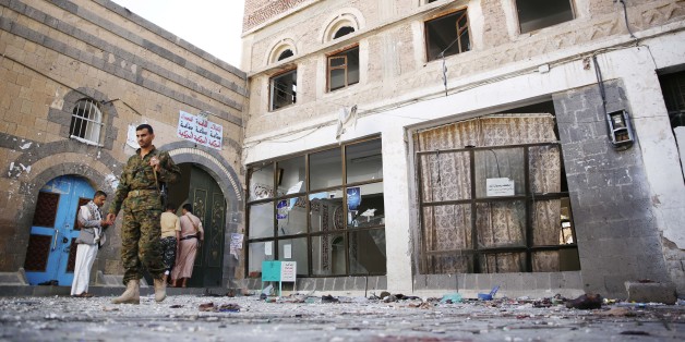Shiite fighters, known as Houthis, inspect the the scene at the al-Balili mosque after two suicide bombings at the mosque during Eid al-Adha prayers in Sanaa, Yemen, Thursday, Sept. 24, 2015. (AP Photo/Hani Mohammed)