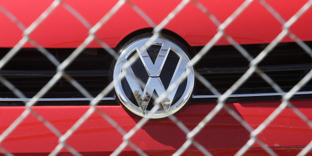 A Volkswagen diesel sits behind a security fence on a storage lot near a VW dealership Wednesday, Sept. 23, 2015, in Salt Lake City. Volkswagen CEO Martin Winterkorn resigned Wednesday, days after admitting that the world's top-selling carmaker had rigged diesel emissions to pass U.S. tests during his tenure. (AP Photo/Rick Bowmer)