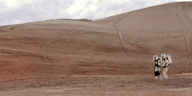 Crew commander Gus Frederick and Greg Drayer, left, explore the terrain outside the Mars Desert Research Station, Monday, April 19, 2004, northwest of Hanksville, Utah. Researchers at the habitat keep a close watch on information retrieved by NASA's Mars rovers, and use it to compare the Red Planet's landscape with the barren desert surrounding them. (AP Photo/Douglas C. Pizac)
