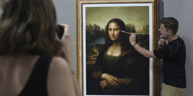 In this Feb. 17, 2015 photo, a foreign visitor poses beside a replica of the famous painting "Mona Lisa" inside the Art in Island Museum in suburban Quezon city, north of Manila, Philippines. The sprawling two-story interactive art museum holds more than 200 paintings, including reproduction of works of masters, animals, Egyptian ruins and others, most of them are three dimensional. (AP Photo/Aaron Favila)