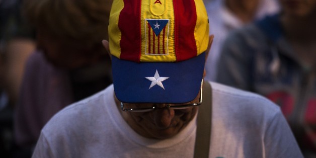 In this Wednesday, Sept. 23, 2015 photo, a pro independence supporter attends a rally of "Junts pel Si" or "Together for YES" in Barcelona, Spain. Catalans vote Sunday in regional parliamentary elections that the breakaway camp hopes will give them a mandate to put their region on a path toward independence _ a goal the Madrid central government says would be illegal. (AP Photo/Emilio Morenatti)