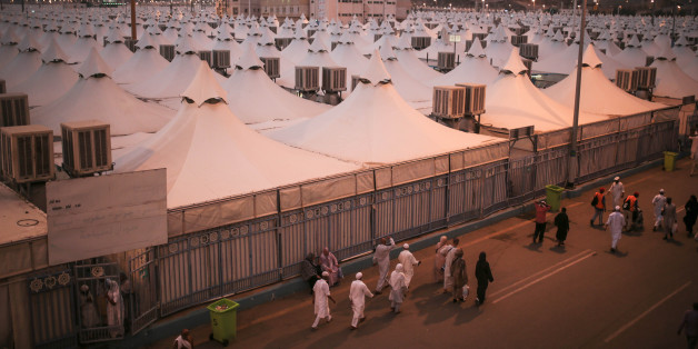 Muslim pilgrims walk past tents, a day after a stampede nearby killed more than 700 people, in Mina, near the holy city of Mecca, Saudi Arabia, Friday, Sept. 25, 2015. Saudi Arabia faced new accusations of neglect Friday in the hajj disaster that killed over 700 people, the second tragedy at this year's pilgrimage overseen by the kingdom's rulers who base their legitimacy in part on protecting Islam's holiest sites. (AP Photo/Mosa'ab Elshamy)