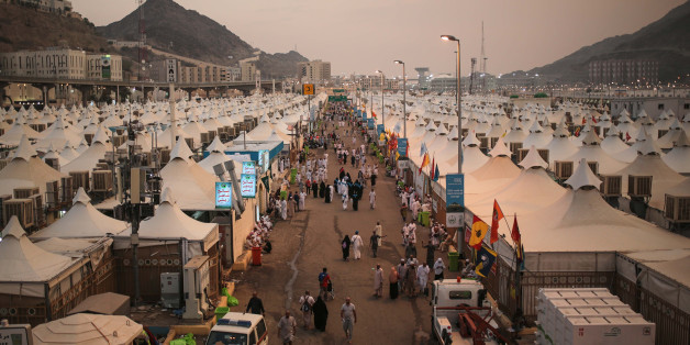 Muslim pilgrims walk past tents, a day after a stampede nearby in which more than 700 people died, in Mina, near the holy city of Mecca, Saudi Arabia, Friday, Sept. 25, 2015. Saudi Arabia faced new accusations of neglect Friday in the hajj disaster that killed over 700 people, the second tragedy at this year's pilgrimage overseen by the kingdom's rulers who base their legitimacy in part on protecting Islam's holiest sites. (AP Photo/Mosa'ab Elshamy)