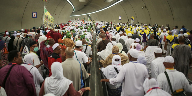 Muslim pilgrims walk in a tunnel on their way to cast stones at Jamarrat pillars, a ritual that symbolises the stoning of Satan, during the annual pilgrimage, known as the hajj, in Mina, near the holy city of Mecca, Saudi Arabia, Friday, Sept. 25, 2015. (AP Photo/Mosa'ab Elshamy)