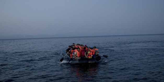 Syrian refugees arrive aboard a dinghy after crossing from Turkey, to the island of Lesbos, Greece, on Sunday, Sept. 20, 2015. Greece's coast guard was searching Sunday for 26 migrants missing off the coast of the eastern Aegean island of Lesbos after the boat they were traveling in sank.(AP Photo/Petros Giannakouris)