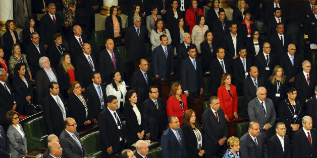 Tunisian parliament members stand during the inaugural session of the newly elected Tunisian parliament in Tunis, Tuesday, Dec. 2, 2014. This is the first national assembly meeting since the October 2014 legislative elections that resulted in a victory for opposition secular parties. (AP Photo/Hassene Dridi)