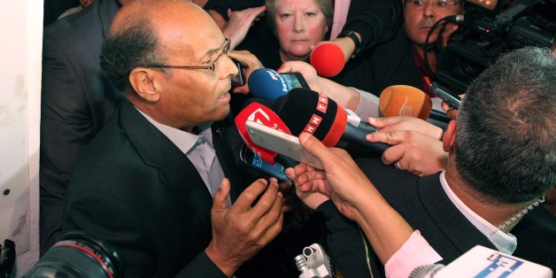 Presidential candidate and Tunisian President Moncef Marzouki addresses media after he casts his vote, during the first round of the Tunisian presidential election, in Sousse, Tunisia, Sunday, Nov. 23, 2014. Tunisia took another step forward in its peaceful transition to democracy on Sunday by holding its first free presidential election, with voters hoping for more stability and a better economy. (AP Photo/Ali Louati)